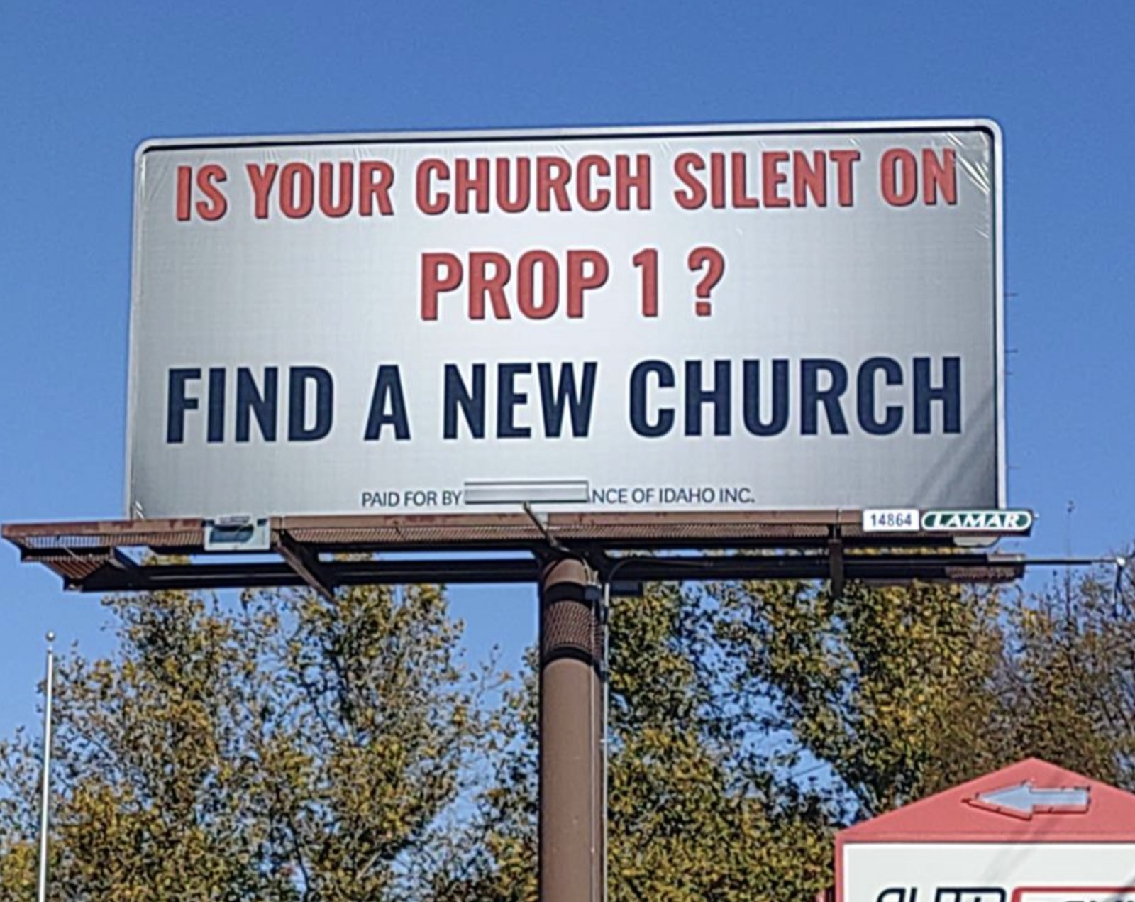 Close-up of a billboard reading Is Your Church Silent on Prop 1? Find a New Church, paid for by Citizens Alliance of Idaho Inc.