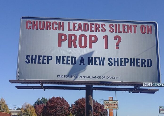 Close-up of a billboard reading Church Leaders Silent on Prop 1? Sheep Need a New Shepherd, paid for by Citizens Alliance of Idaho Inc.