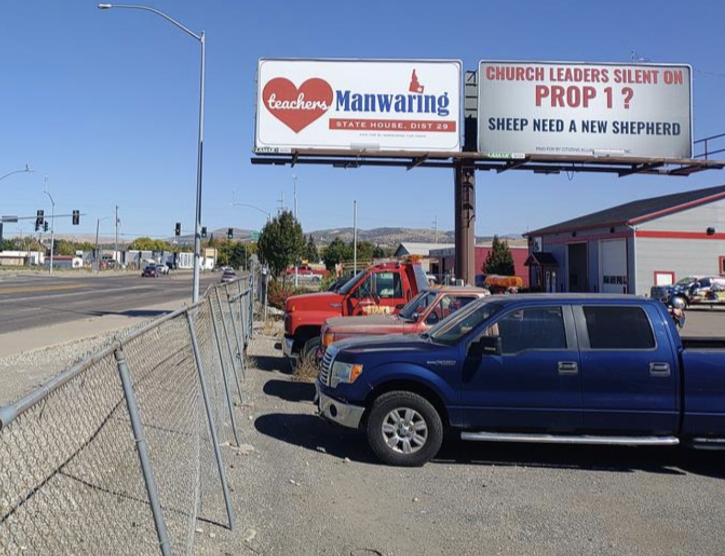 A billboard reading Church Leaders Silent on Prop 1? Sheep Need a New Shepherd, seen from a city street